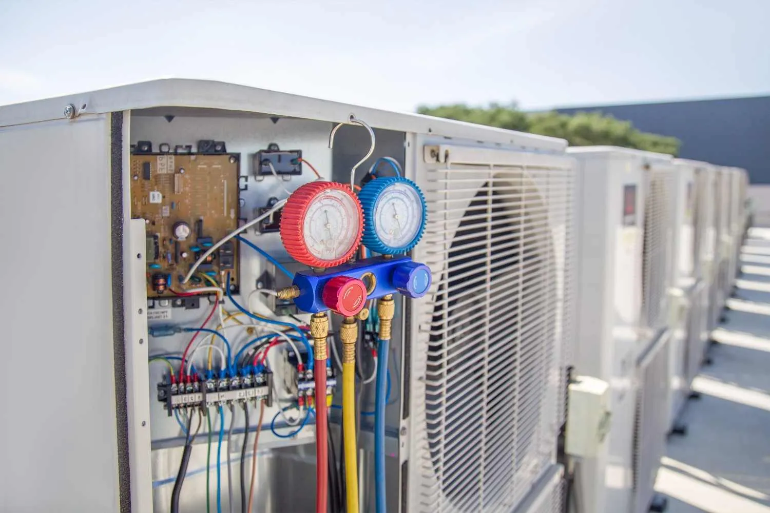 Gauges hooked up to an outdoor air conditioning unit
